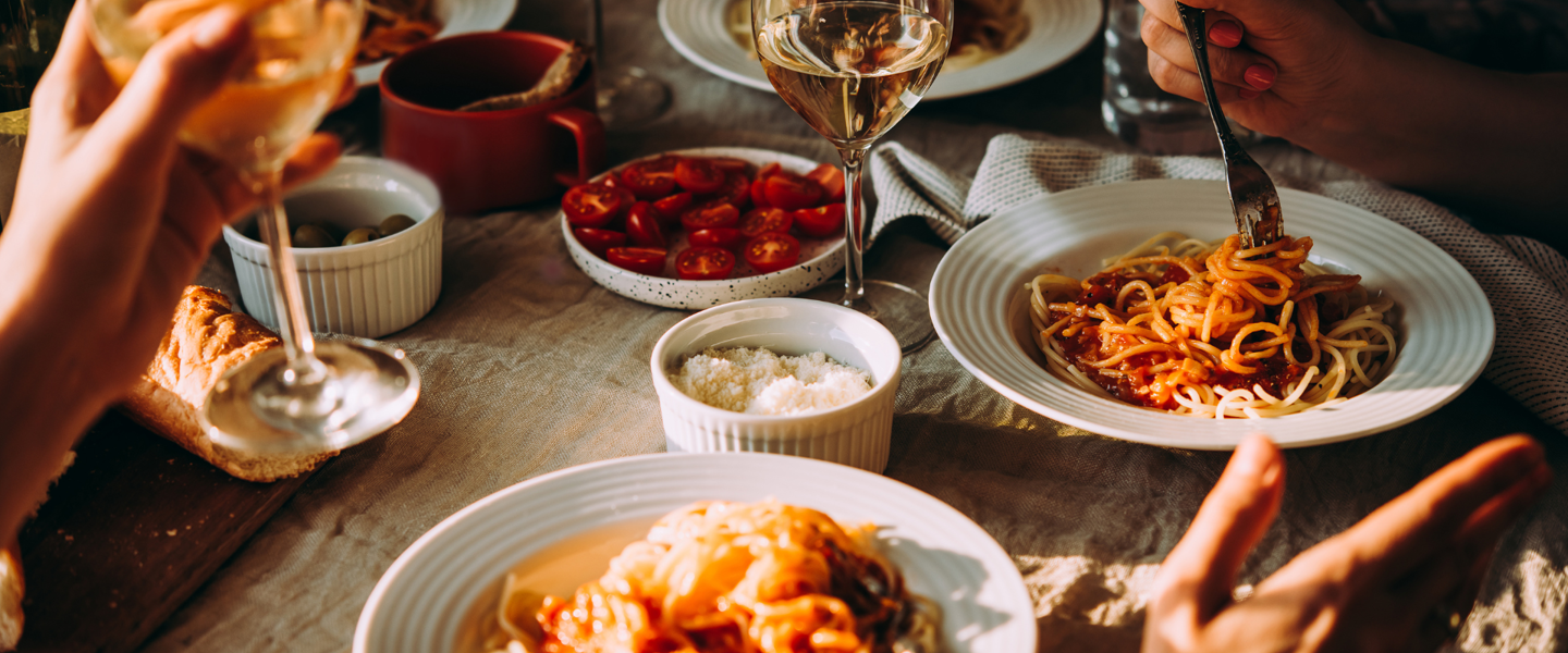 People Eating Italian Food And Drinking Wine