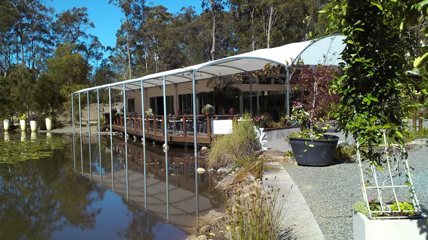 Outdoor dining space at Abundance Cafe with beautiful lake view